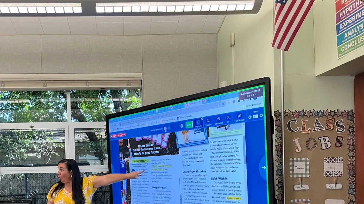Teacher using Promethean board with checklist for moving from classroom projector to Promethean board