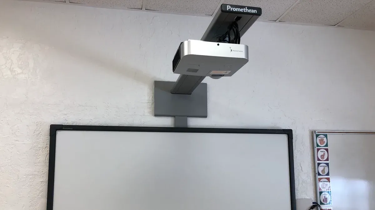 Teacher switching from Promethean board to classroom projector in a classroom